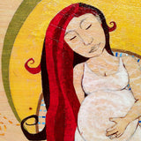pregnant woman with red hair and eyes closed