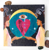 Painting on wood panel of a black woman and a white woman with a heart, a crying eye, a crescent moon, a large blue clock face, and silvery moths. By Portland artist Lea K. Tawd.