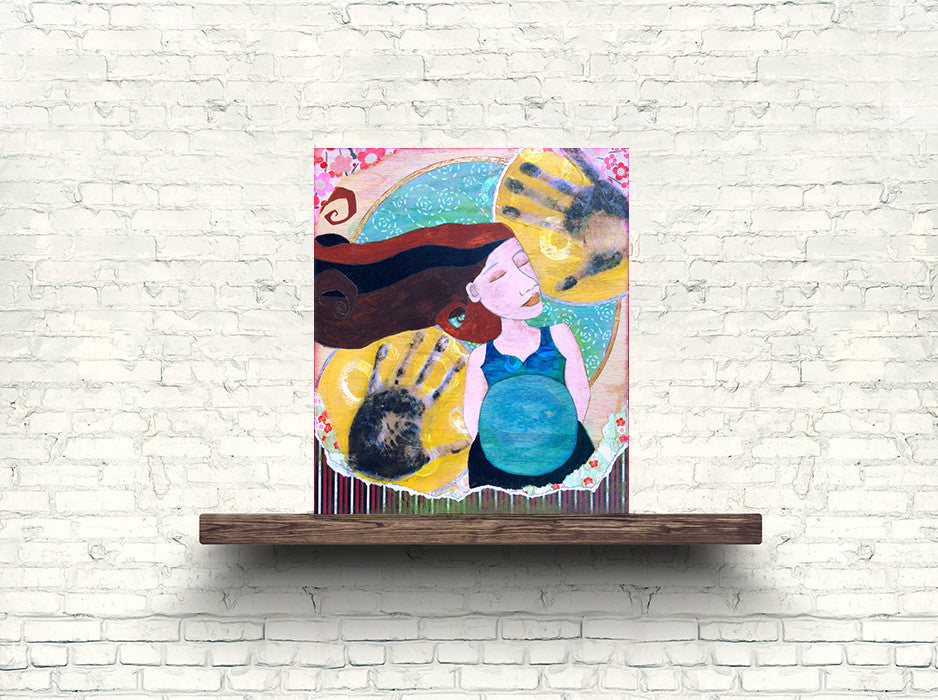 pregnant mom artwork on a wooden shelf in front of a white brick wall