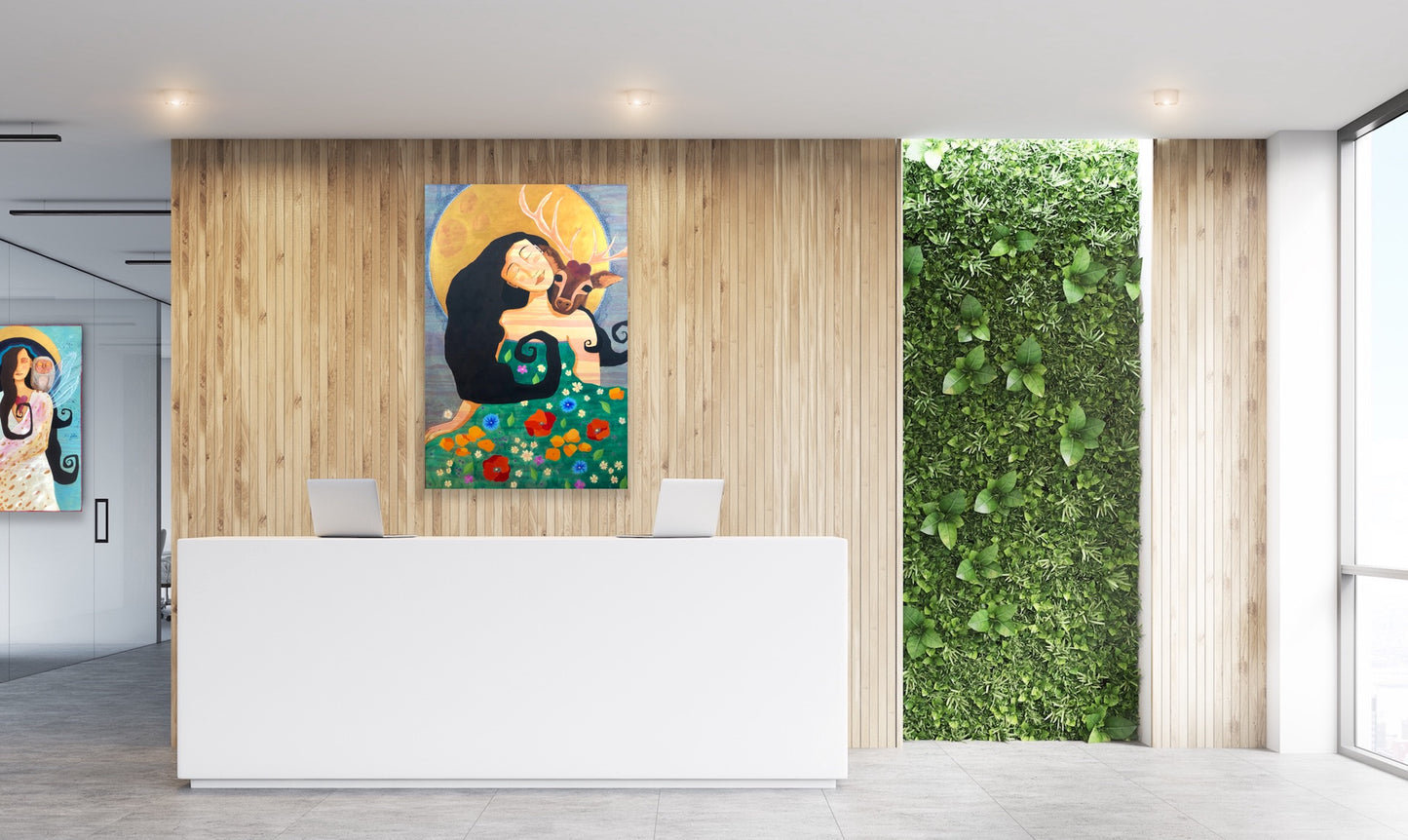 Medical or wellness office front desk decorated with a painting of a woman, deer and full moon and a window filled with greenery.