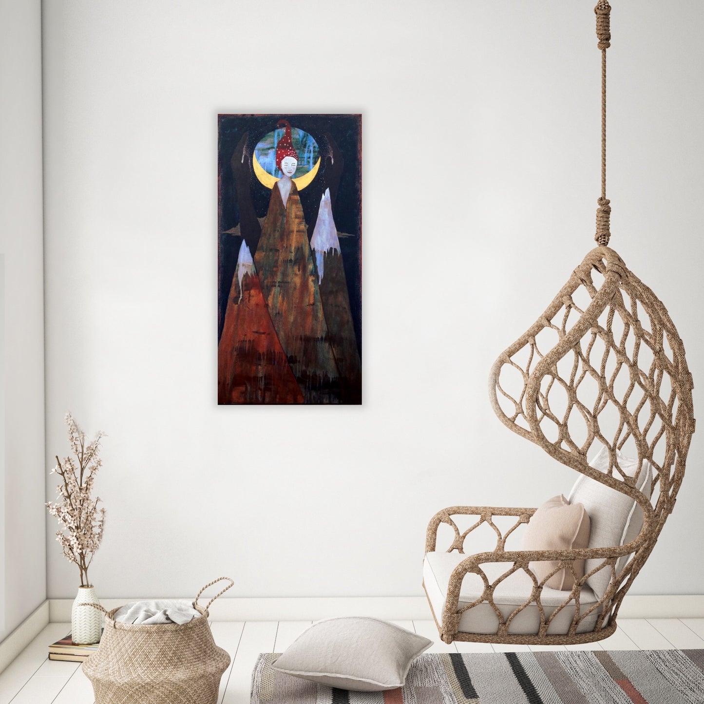 spiritual feminine artwork hanging on a white wall in a living room with a chair suspended from the ceiling, a basket and a pot of flowers